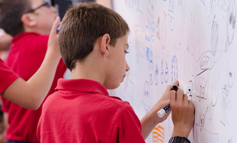 detail photo of a kid drawing on a ZURB whiteboard